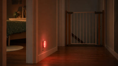 Veilleuse branchée sur une prise dans un couloir la nuit, devant la chambre d'un enfant